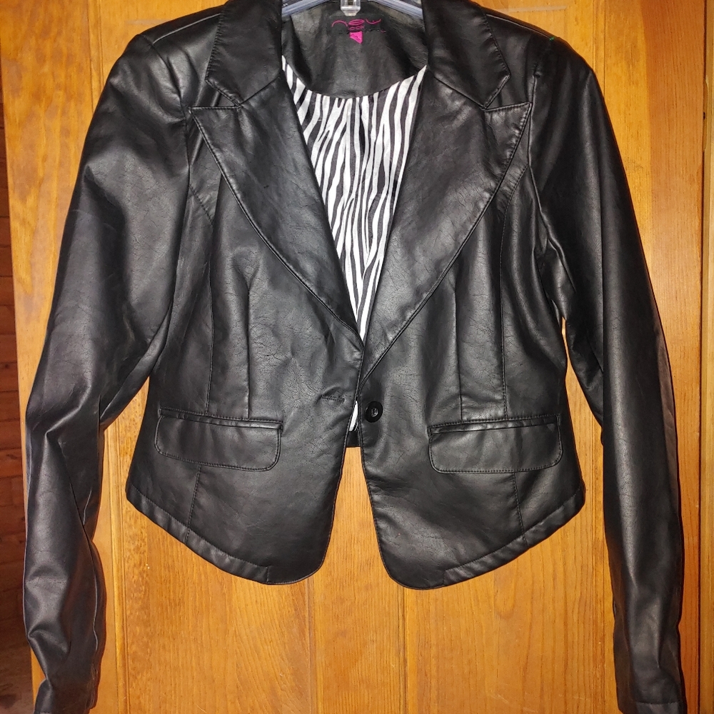 Waist length leather look jacket.  Not genuine.